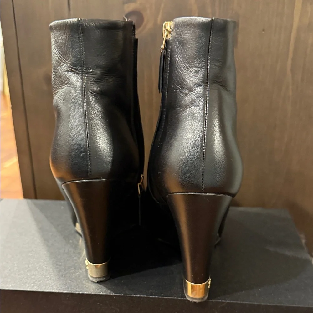 CHANEL Black Leather Wedge Boots with Gold Accent